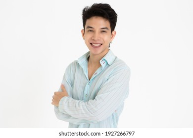 Young And Handsome Teenage Black Hair Asian Man Wearing Earrings Cross Arms Pose On White Background.