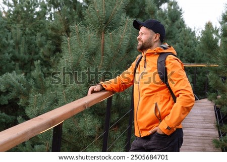 Similar – Image, Stock Photo Man in Orange Jacket Enjoying Misty Iceland Landscape
