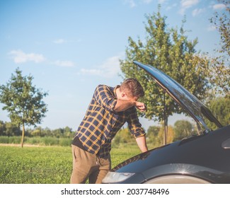 Young Handsome Upset Man With Broken Car In The Middle Of Nowhere