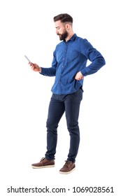 Young Handsome Well Dressed Business Man Surfing Internet On Smart Phone. Side View. Full Body Isolated On White Background.