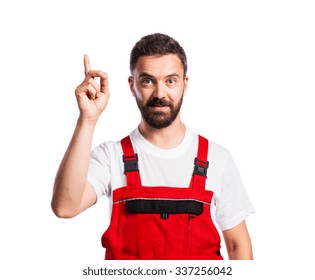 Young Handsome Worker In Red Overalls. Studio Shot On White Background