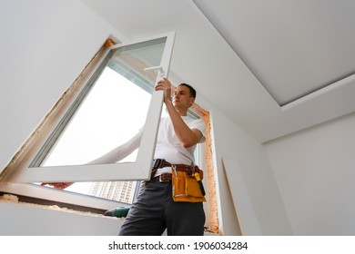 Young Handyman Repair Window With Screwdriver