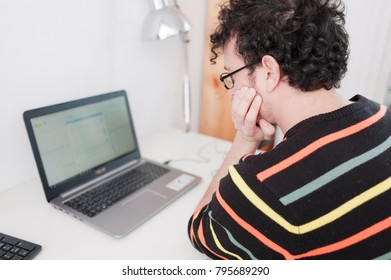 Young hansome bearded man working at his home office - Shutterstock ID 795689290