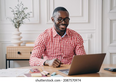 Young Happy African American Man Office Worker Chatting Online With Business Partner While Working On Laptop Pc, Smiling Dark Skinned Entrepreneur Enjoying Remote Work From Home