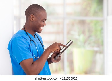 Young Happy African American Medical Worker Using Tablet Computer