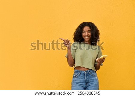 Similar – Image, Stock Photo Young black female standing in studio against yellow and blue lights