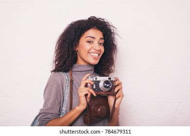 A Young Happy Afro American Woman Photographer Holding Retro Fil