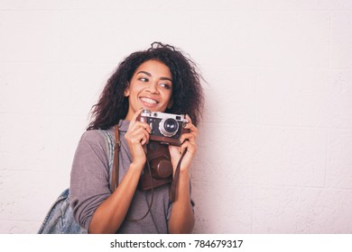 A Young Happy Afro American Woman Photographer Holding Retro Fil