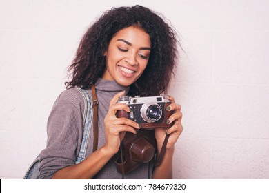 A Young Happy Afro American Woman Photographer Holding Retro Fil