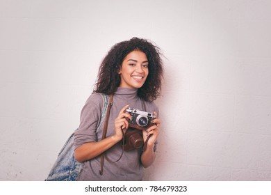 A Young Happy Afro American Woman Photographer Holding Retro Fil