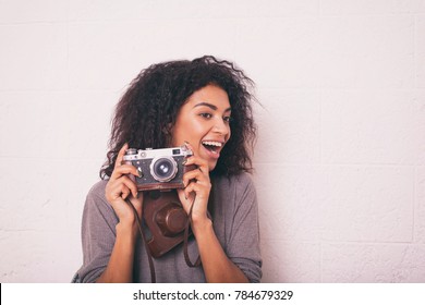 A Young Happy Afro American Woman Photographer Holding Retro Fil