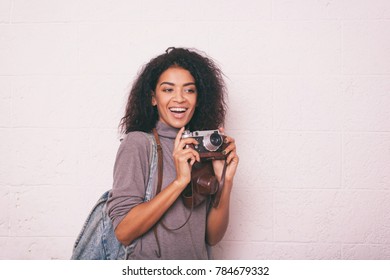 A Young Happy Afro American Woman Photographer Holding Retro Fil