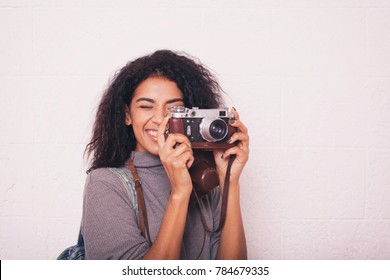 A Young Happy Afro American Woman Photographer Holding Retro Fil