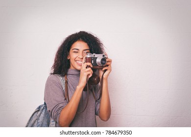 A Young Happy Afro American Woman Photographer Holding Retro Fil