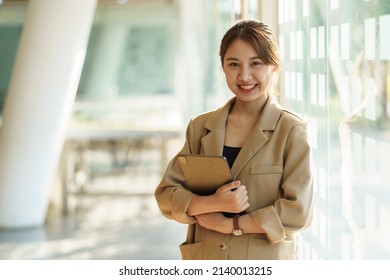 Young happy asian businesswoman with tablet computer in office,Asian woman working with tablet, concept of using tablet to communicate in the office - Powered by Shutterstock