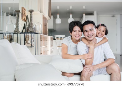 Young Happy Asian Family At Home.