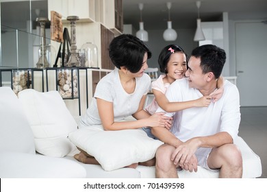 Young Happy Asian Family At Home.