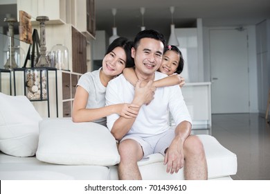 Young Happy Asian Family At Home.