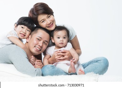 Young Happy Asian Family With Kids.
