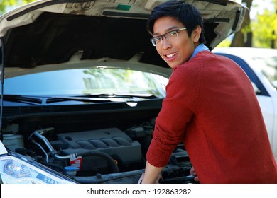 Young Happy Asian Man Checking His Car Engine