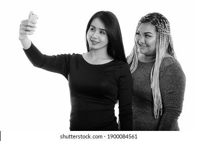 Young Happy Asian Transgender Woman And Fat Asian Woman Smiling While Taking Selfie Picture With Mobile Phone