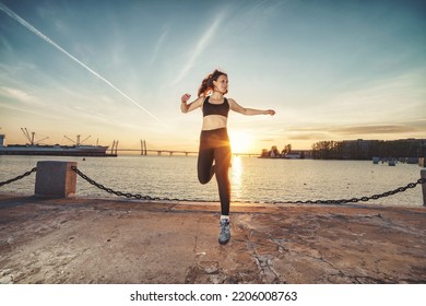 Young happy athletic looking woman jumping up against sea and sunset sky. Happy woman, photo in the air at the moment of the jump - Shutterstock ID 2206008763