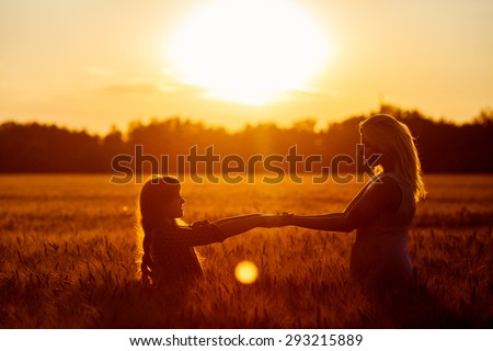 Similar – Schwestern sitzen auf einer Wiese im Sonnenuntergang