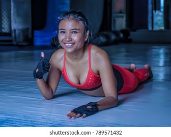 Young Happy And Beautiful Sweaty Asian Woman In Sport Clothes Stretching On Gym Dojo Floor Smiling Posing Corporate In Hard Training Workout And Healthy Sporty Lifestyle Concept Giving Thumb Up