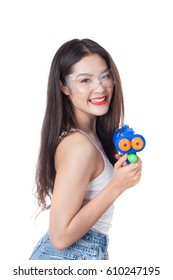Young happy beauty Asian woman holding plastic water gun at Songkran festival, Thailand. Isolated on white background.