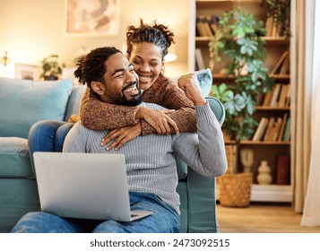 Young happy black couple having fun using a laptop at home - Powered by Shutterstock