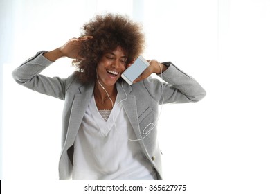 Young happy  black student dancing an listening to the music