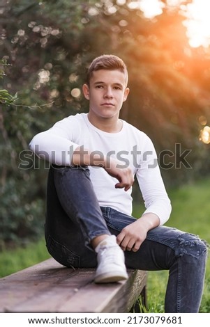 Similar – Image, Stock Photo Stylish teenager sitting on a wooden bench