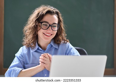 Young happy business woman employee or teacher feeling excited looking at laptop reading good news online getting salary or new job opportunity, satisfied with great result sitting at work desk. - Powered by Shutterstock