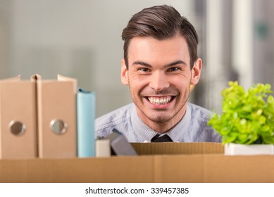 Young Happy Businessman With Boxes To Move To New Office