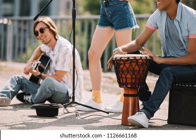 Young Happy Buskers Performing And Singing At City Street