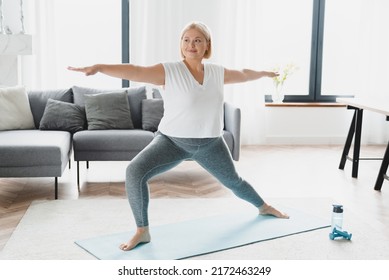 Young happy caucasian plus size plump woman athlete doing yoga training slimming shaping exercises, burning calories weight at home on fitness mat