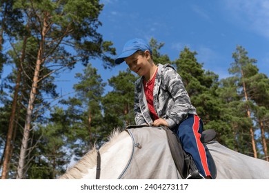 A young, happy child, with a big smile on their face, riding a beautiful white horse through the picturesque summer countryside, enjoying the warm sunshine and fresh air. - Powered by Shutterstock