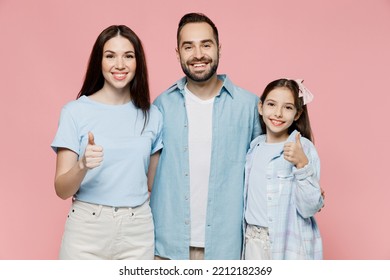 Young Happy Cool Parents Mom Dad With Child Kid Daughter Teen Girl In Blue Clothes Showing Thumb Up Like Gesture Isolated On Plain Pastel Light Pink Background. Family Day Parenthood Childhood Concept