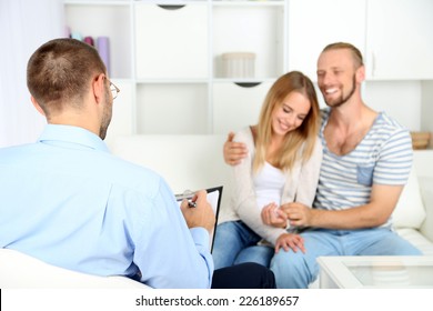 Young Happy Couple After Therapy Session With Family Psychologist