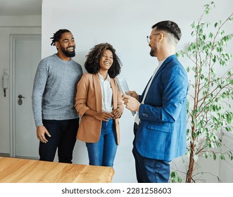 Young happy couple and an agent in a new property - Shutterstock ID 2281258603
