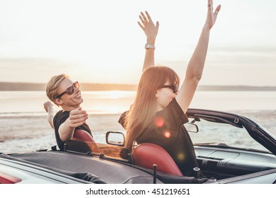 young happy couple in cabriolet in sunset light - Powered by Shutterstock