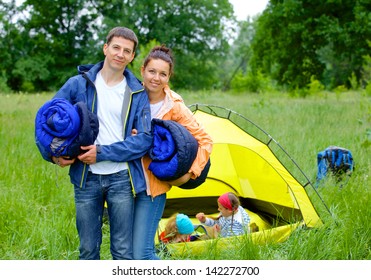 Young Happy Couple Camping Near Tent In Park