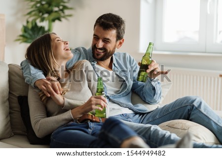Similar – Image, Stock Photo Cheerful girlfriends with beer spending weekend on sofa