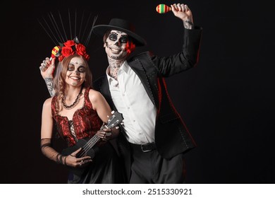 Young happy couple dressed for Mexico's Day of the Dead (El Dia de Muertos) with maracas  playing guitar on black background - Powered by Shutterstock