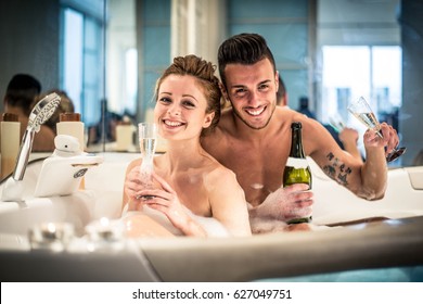 Young happy  couple enjoying an hot bath in the jacuzzi