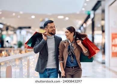 Young happy couple enjoying in shopping day at the mall. Copy space.  - Powered by Shutterstock