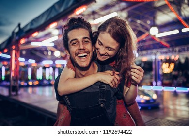 Young happy couple/ Young happy couple enjoying themselves at the amusement park - Powered by Shutterstock