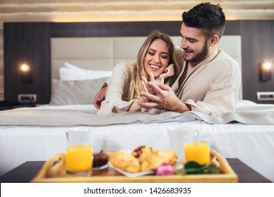 Young Happy Couple Having Breakfast In Luxury Hotel Room. 