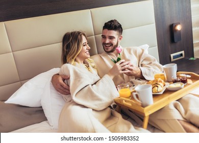 Young Happy Couple Having Breakfast In Luxury Hotel Room