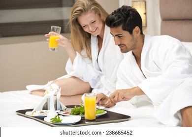 Young Happy Couple Having Breakfast In Luxury Hotel Room